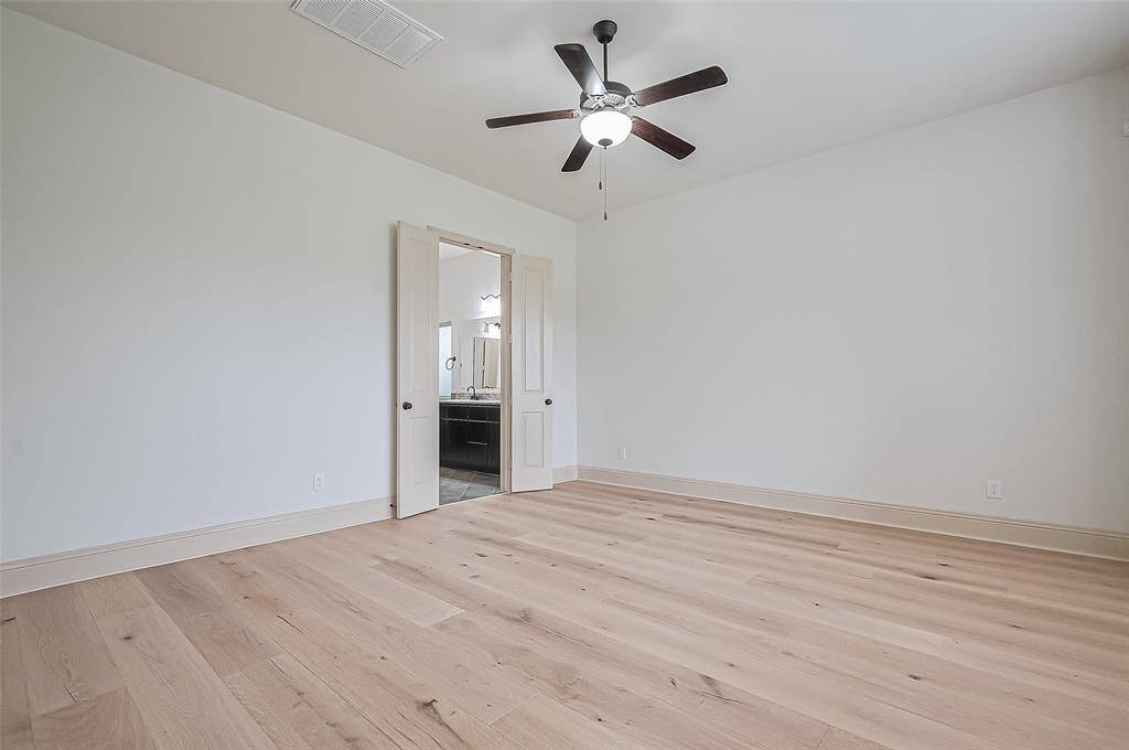 Virtually staged view of primary bedroom with views to the lake.