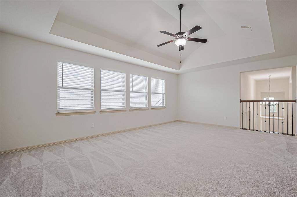 Oversized playroom with tray ceilings.
