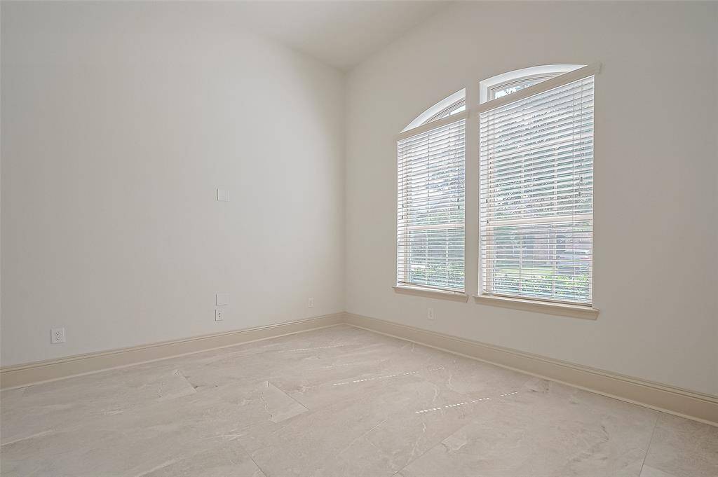 The formal dining room next to the study presents cathedral high ceilings