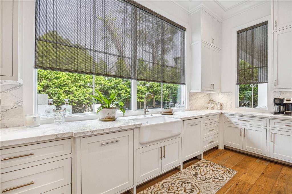 The kitchen sink overlooks the beautifully landscaped backyard and pool area.