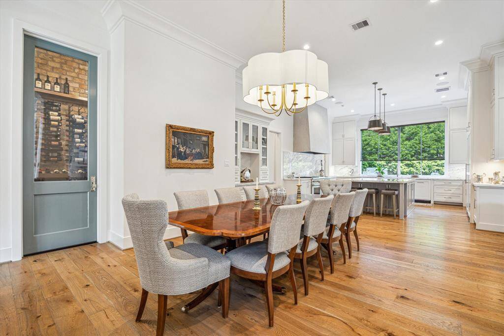The kitchen and breakfast room flow together to create a wonderful gathering space for family or entertaining.  Note the wine room behind the blue door to the left and the built-in china cabinet on the far side of that wall.
