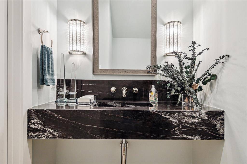 Titanium polished marble lends extra sophistication to this main-floor powder room.