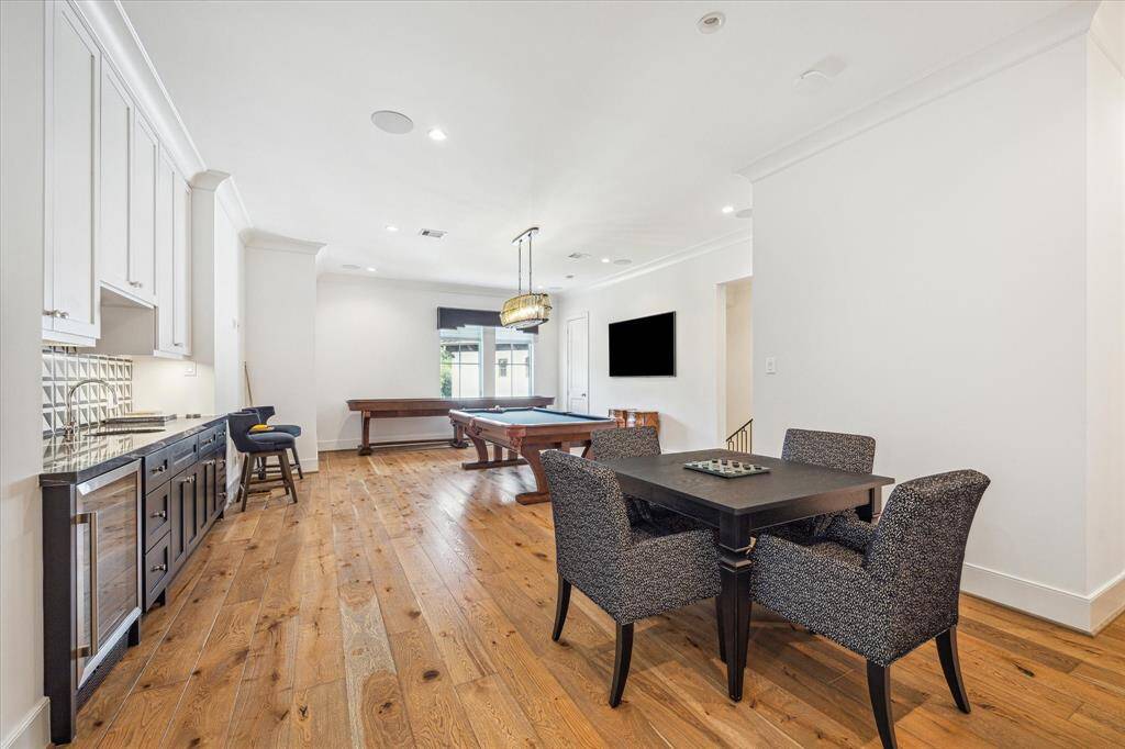 The second floor game room has plenty of room for whatever your needs.  The beverage station offers convenience to both you and your guests.  The back staircase is easily accessed via the game room.
