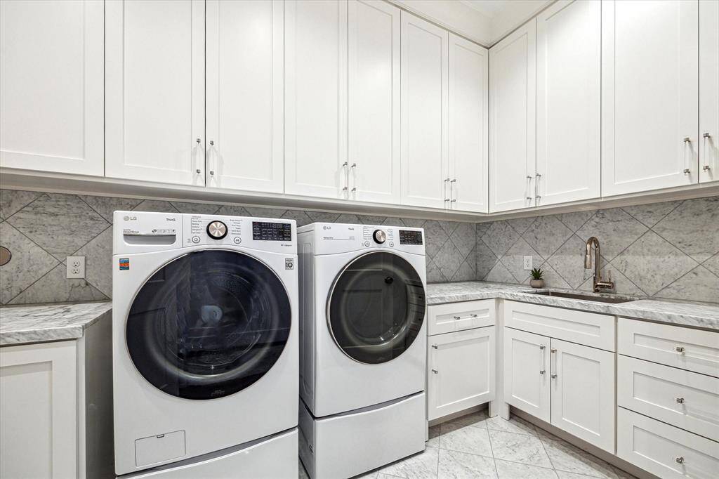 This second floor laundry room will make laundry not such a chore.  With upper and lower cabinetry for storage, marble countertops for folding, and a soaking sink, laundry has never been easier.