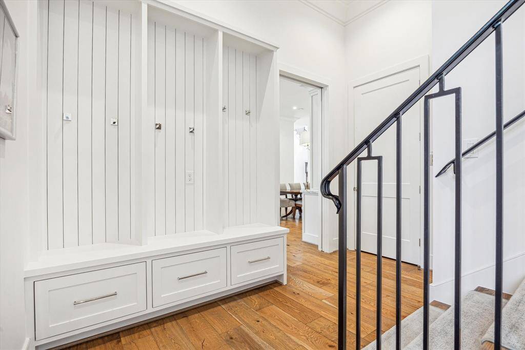 Thoughtfully placed mud room storage located at the base of the back stairs, right by the garage entry.  Door to the right of kitchen entry is the elevator.