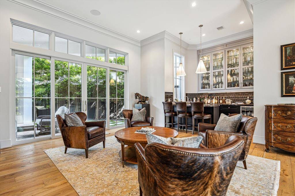 The formal living room is a great space for entertaining or cozy nights in. The glass doors provide an expansive view of the backyard and open easily to bring the outdoors in. Transom windows above bring in additional light.