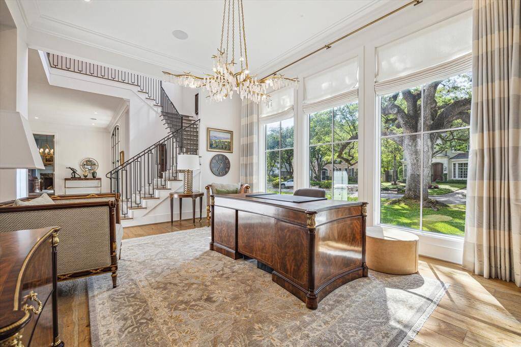 The spacious dining room, currently being utilized as a home office, looks out on the beautifully landscaped front yard through floor to ceiling windows.  The size of the dining room is perfect for grand scale entertaining.