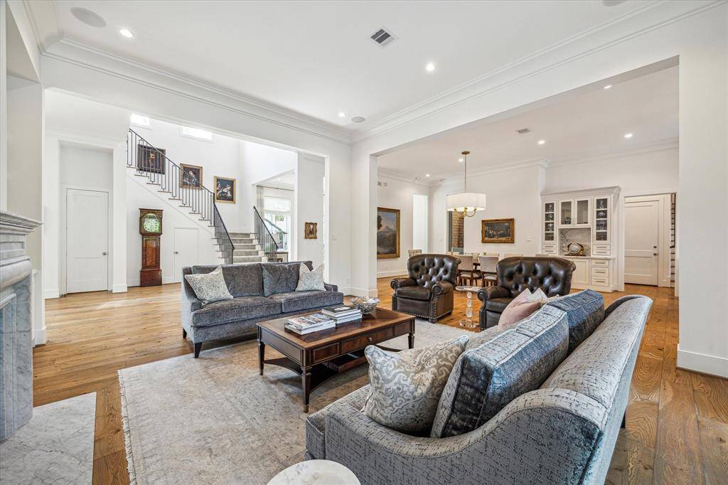 Central to the home, the family room seamlessly connects to the breakfast room and kitchen, with easy access to the front stairway.  The powder room is located through the door to the left of the stairway.