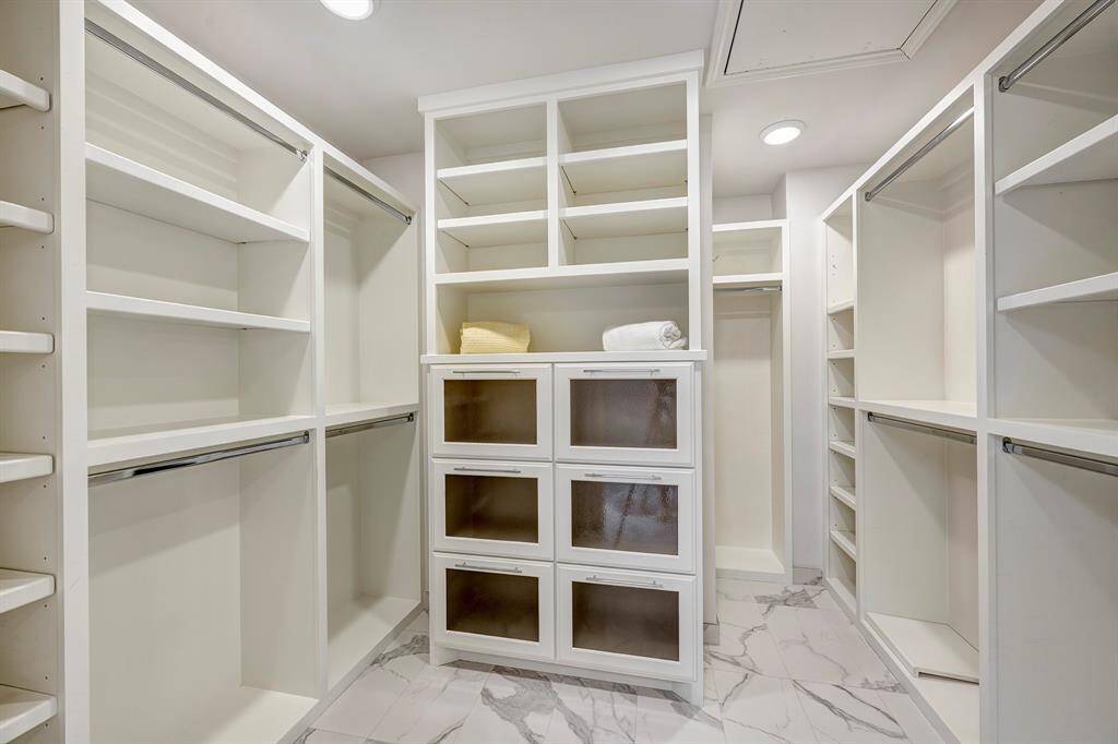 Fill me up said the walk in closet. Storage for shoes and purses. Double rods for hanging.