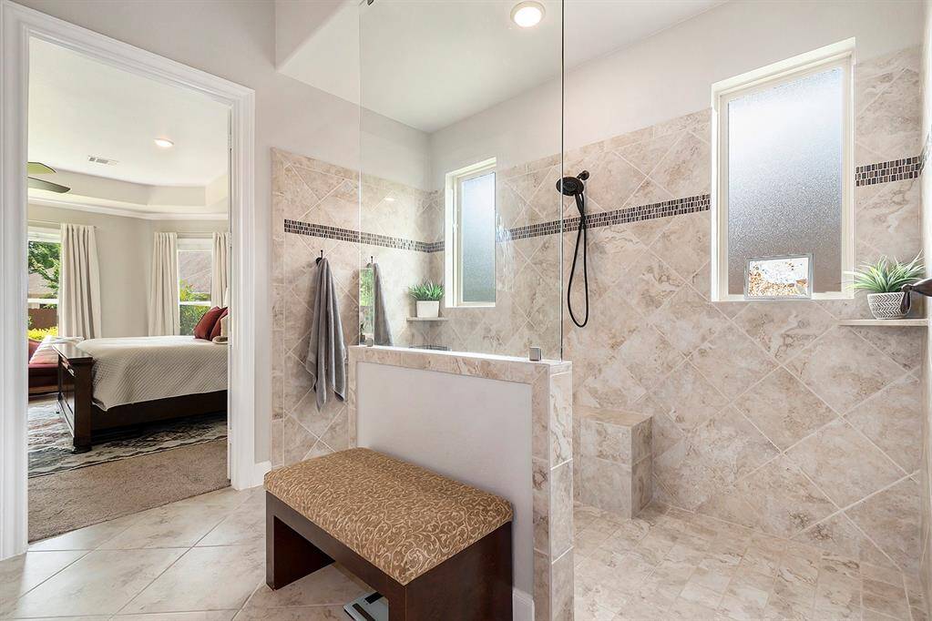 Oversized shower with bench in primary.