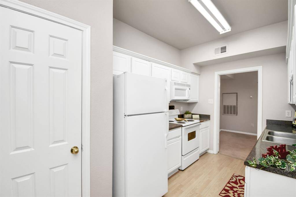 A stackable washer and dryer are sold with the home.