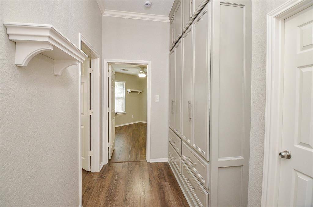 Clever use of wall space in this hallway, offers floor-to-ceiling custom cabinetry.