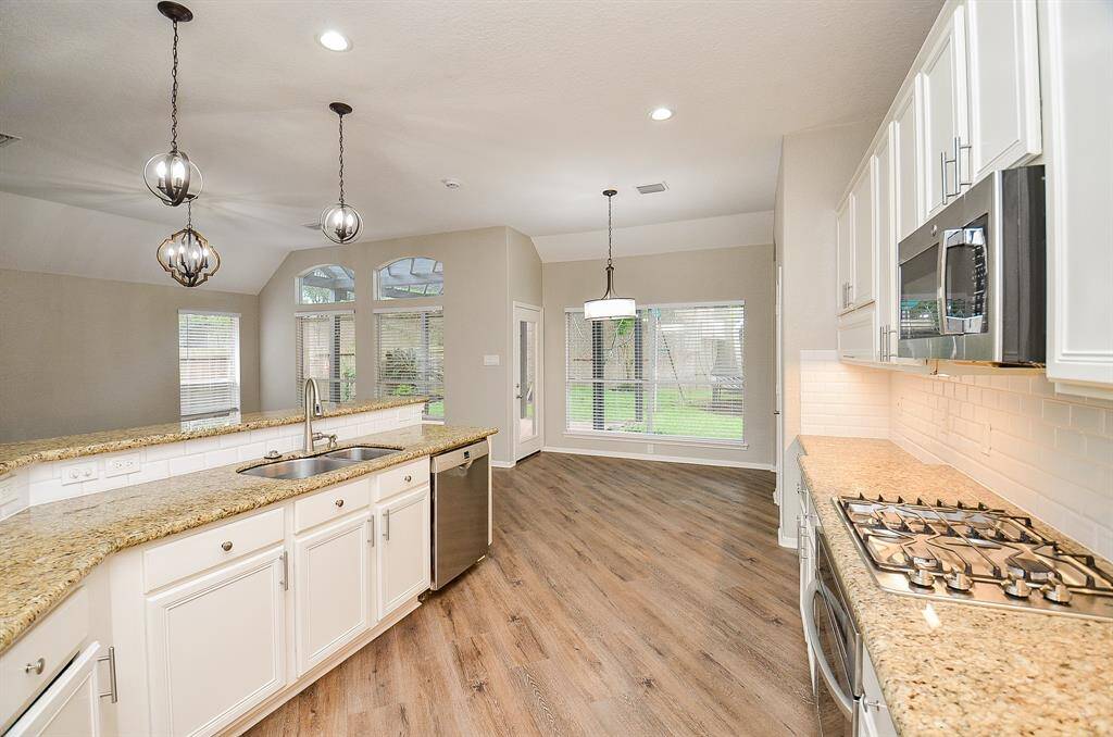It's clear sailing from kitchen to breakfast nook; and socializing while you're in your kitchen 'workshop', creating culinary magic while family and guests gather in the living area, left.