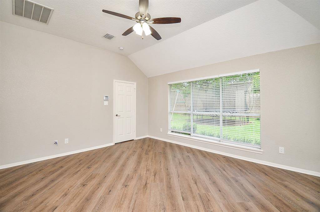 This is your one-of-a-kind primary suite; your personal place of peace and repose! The high angled ceiling is a comforting view; with triple windows providing a glimpse of lush nature in the backyard.