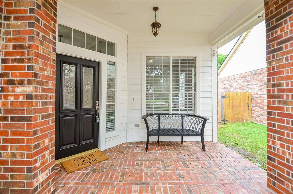 Good looking and sturdy brick flooring lines the spacious front porch and impressive covered front entrance.