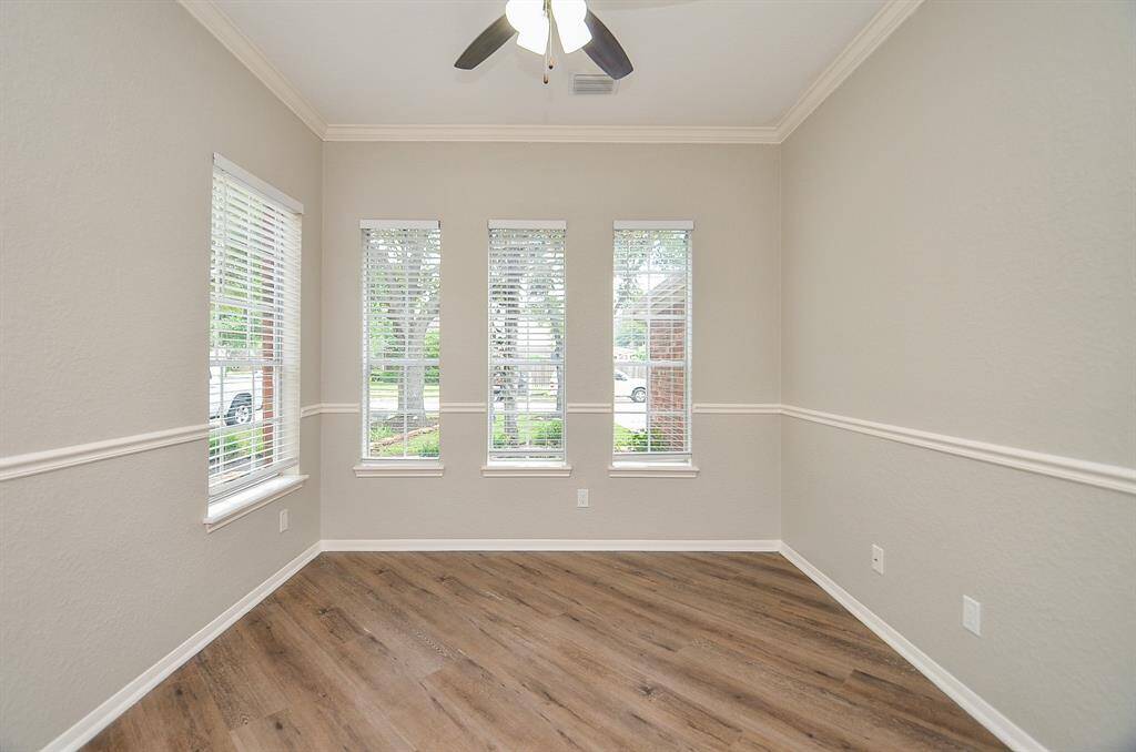 A lovely array of windows span the walls in the home office space.