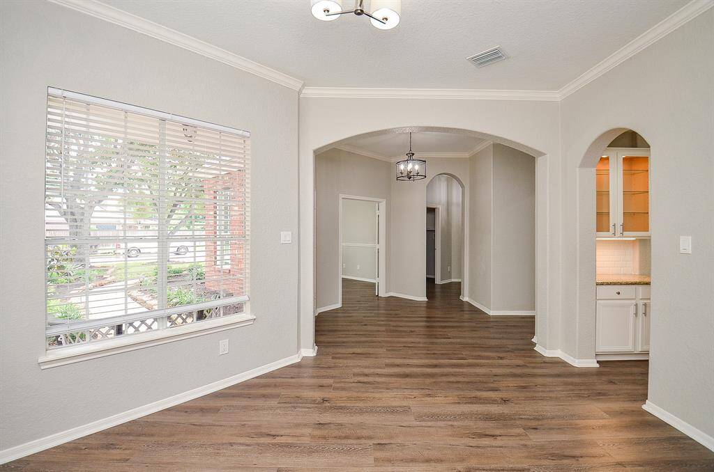 Opposite the home office is your inviting formal dining space, with direct access to the chef's kitchen, through the arched doorway, right.
