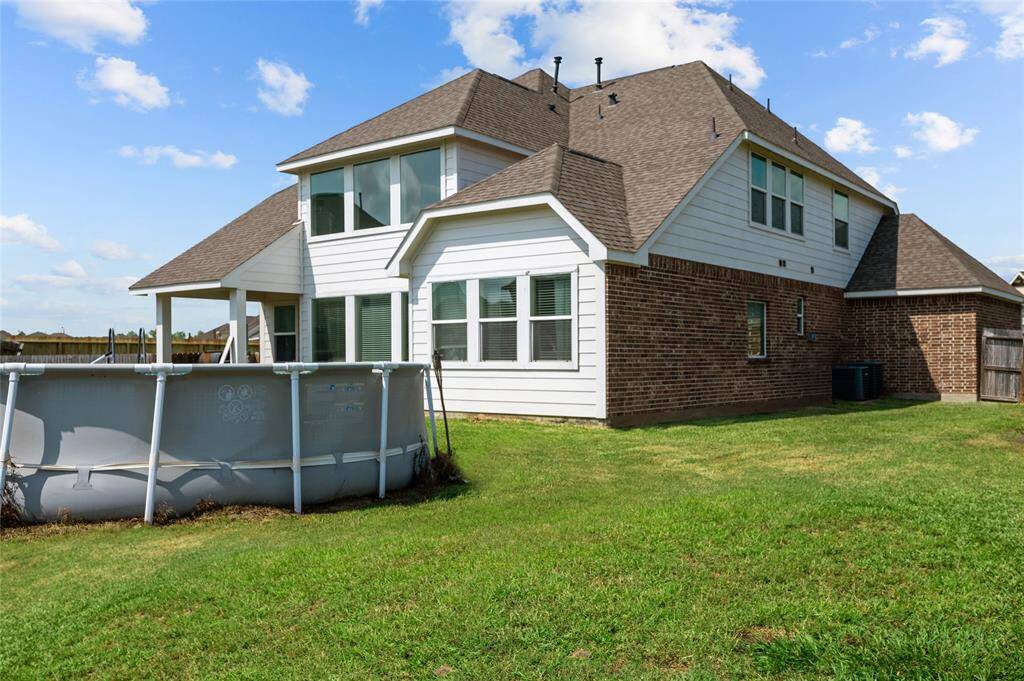 Rear exterior view. There’s an above ground pool which is included in the sale.