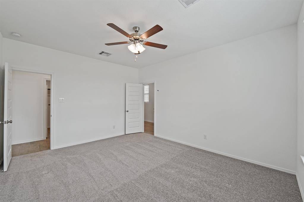 The Primary Suite offers plush carpeting, ceiling fan and easy access to the Primary Bathroom Oasis to retreat to after a long day.