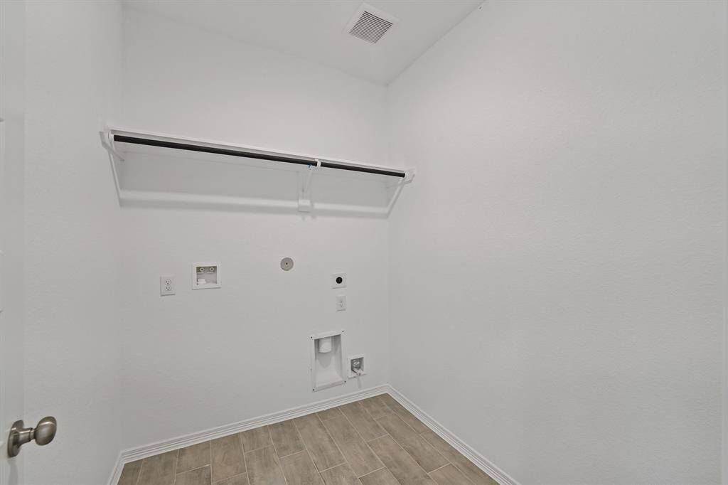 An In House Utility Room with Drying Rack and extra storage above!