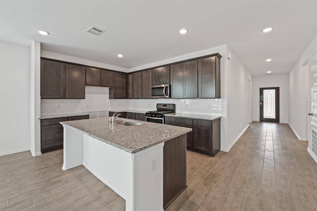 Gourmet Kitchen offers a Grand Granite Island, Stainless Steel Appliances, and Walk In Pantry adding to the elegance and ambiance of this exquisite space.