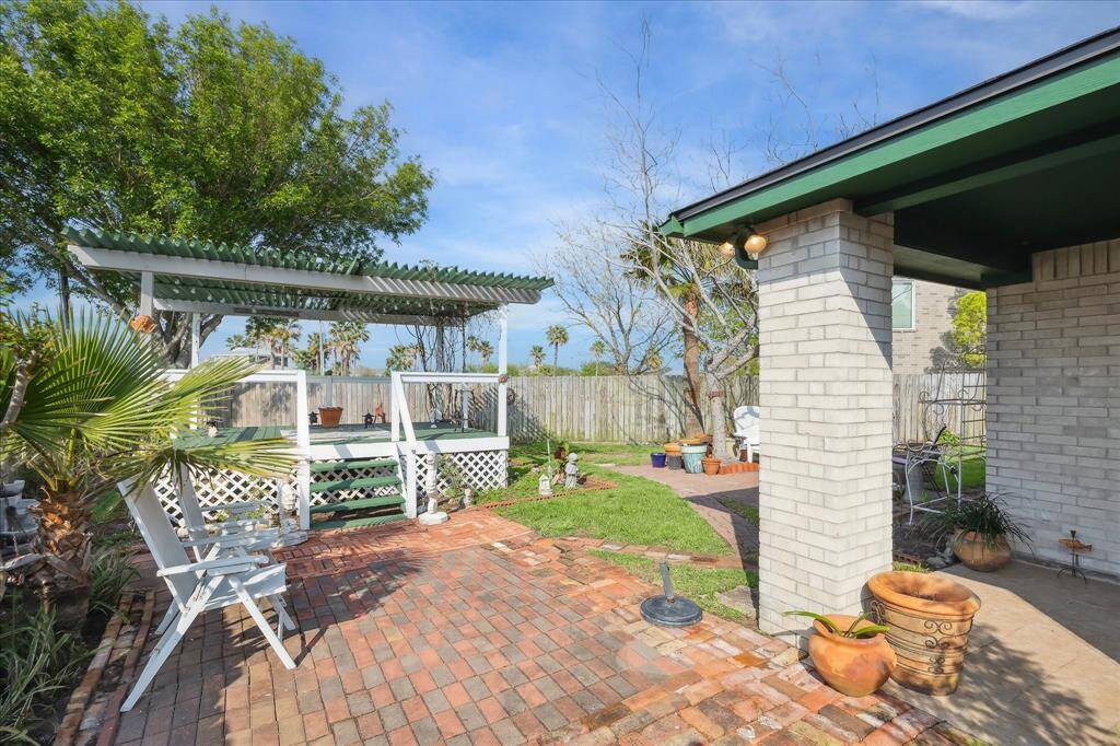 COVERED PORCH STEPS OUT TO 2 BRICK PATIOS