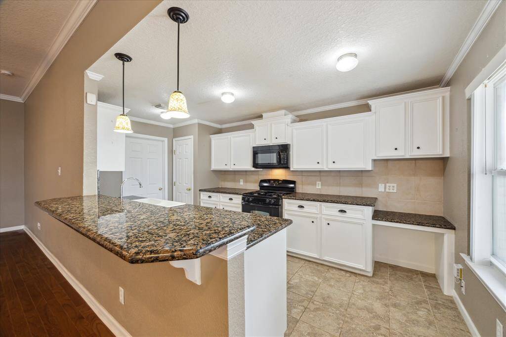 GRANITE COUNTER TOPS / PLENTY OF CABINETS FOR STORAGE AND A DESK FOR A SMALL OFFICE SPACE.
