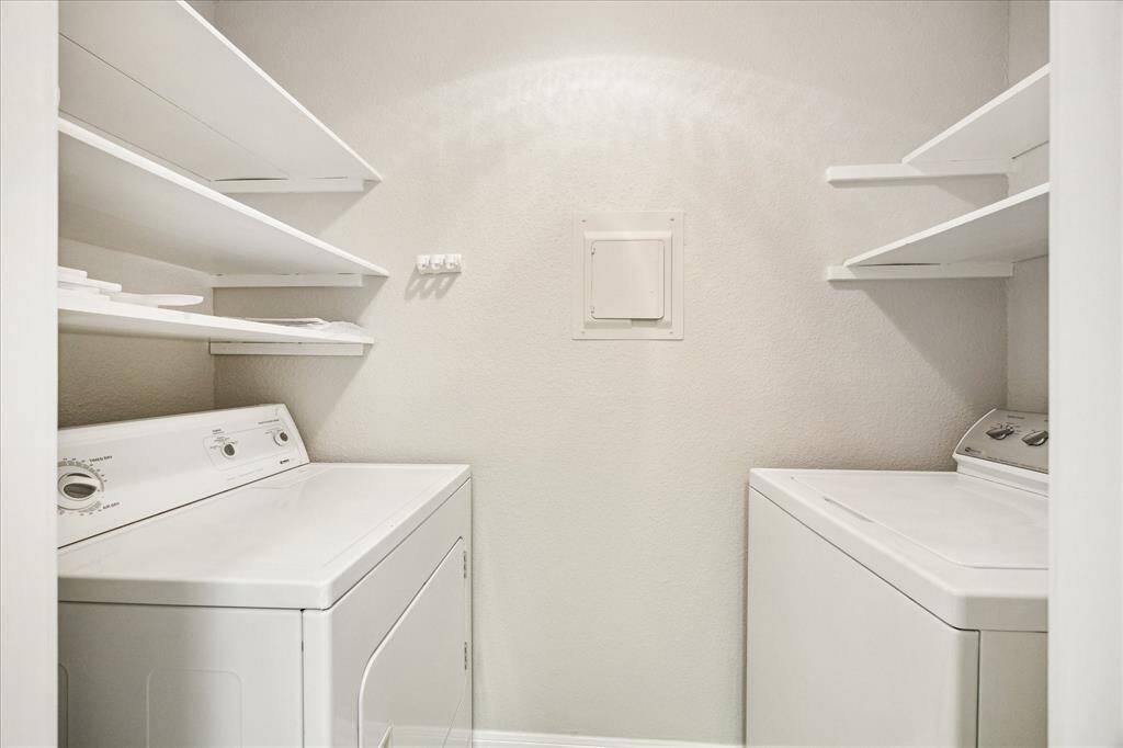 Laundry room with full size washer & dryer and lots of storage.