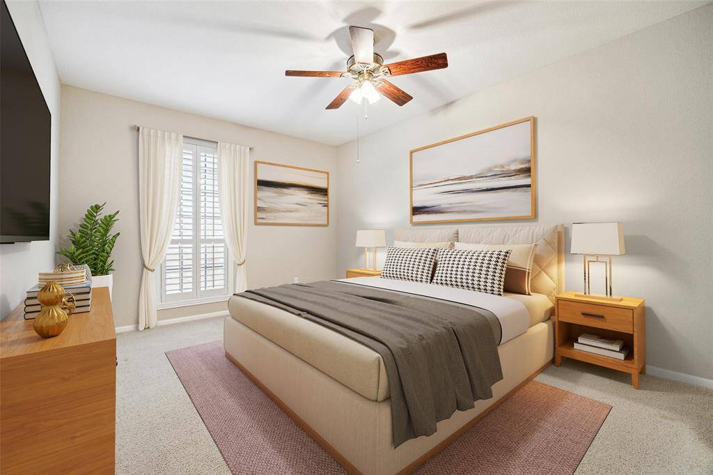Large primary bedroom with plantation shutters.Virtually staged.