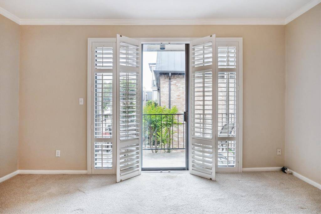 Great balcony off the living room with plantation shutters.