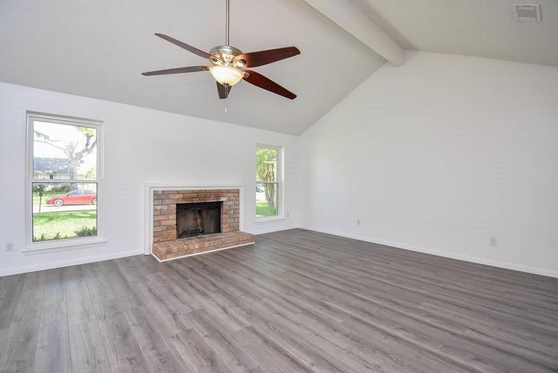 Oversized family room with wood burning fireplace & great windows