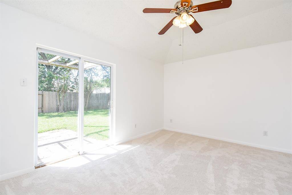 Primary bedroom with doors that lead to rear yard