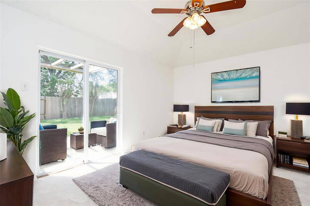 Primary bedroom with doors to back yard