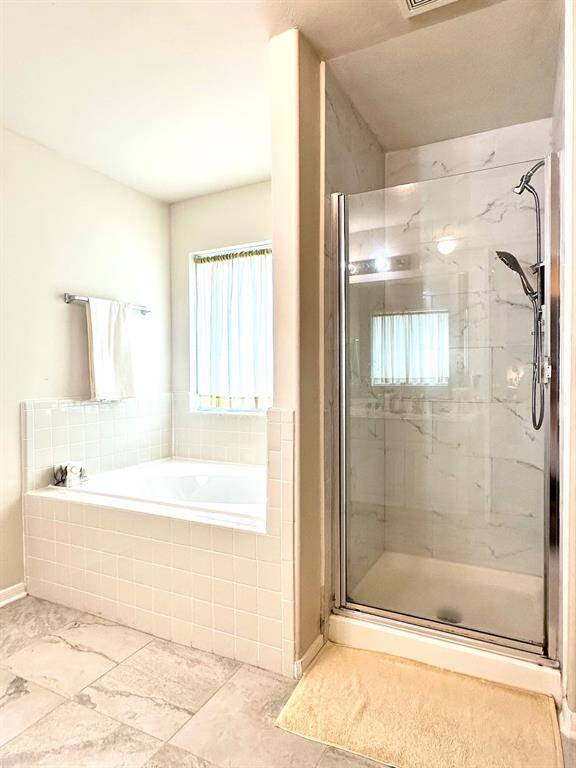 Walk in shower and soaking tub in the primary bath!