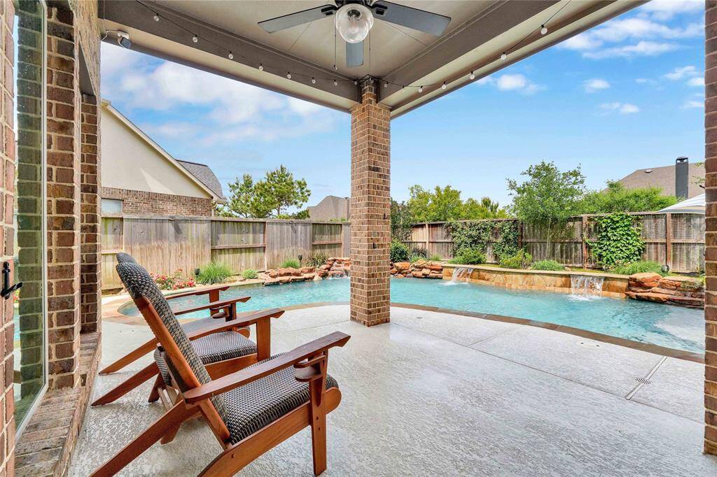 Extended covered patio with view of waterfalls
