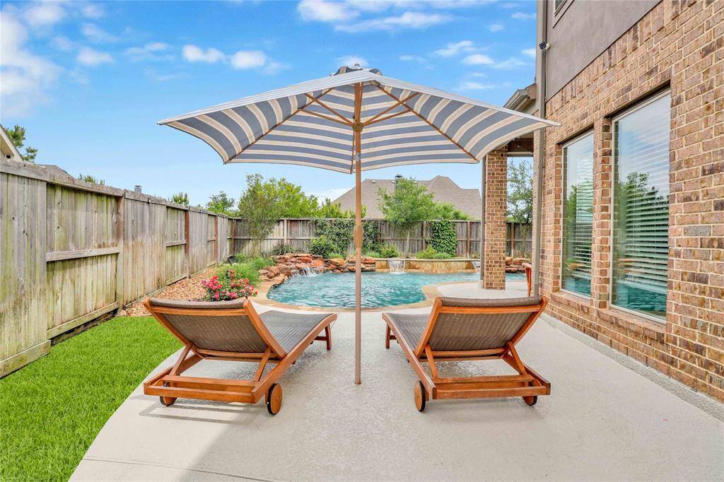 Peaceful shaded tanning area with view of deep end
