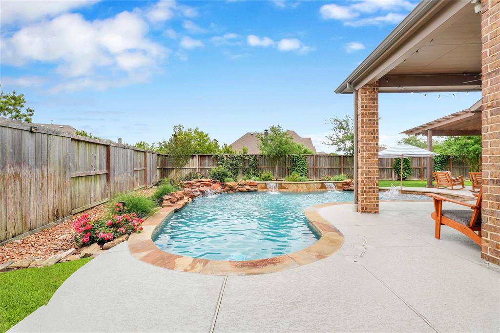 Custom rock beds and landscaping complete the oasis vibe