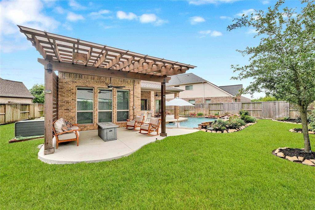 Custom added pergola with ceiling fans and lights hookup