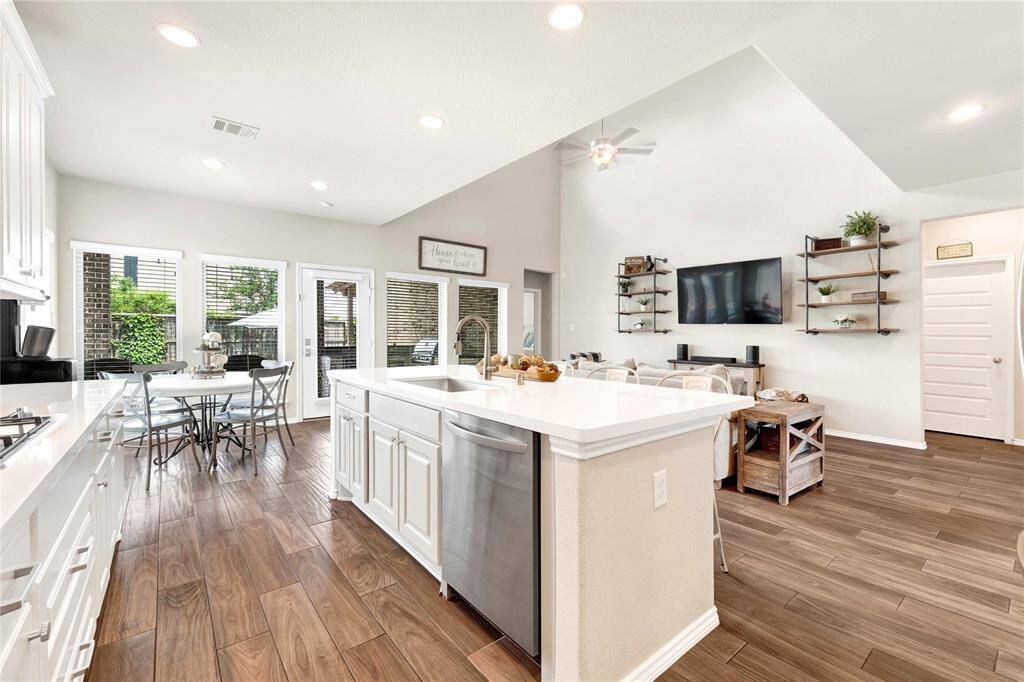 Sink faces to living room with outlets on island
