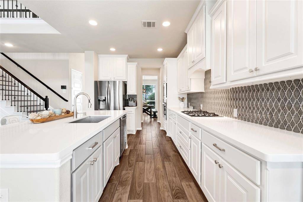 Extended kitchen leads to pantry, a private half bathroom, and dining space