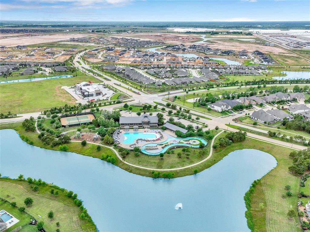 View of THE SHED where lazy river pool, tennis courts, fitness center, playground, clubhouse are all located