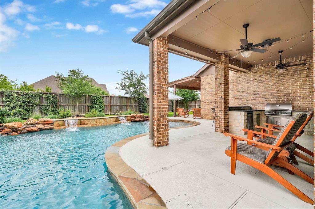 Custom Covered Patio equipped with ceiling fans and TV outlets