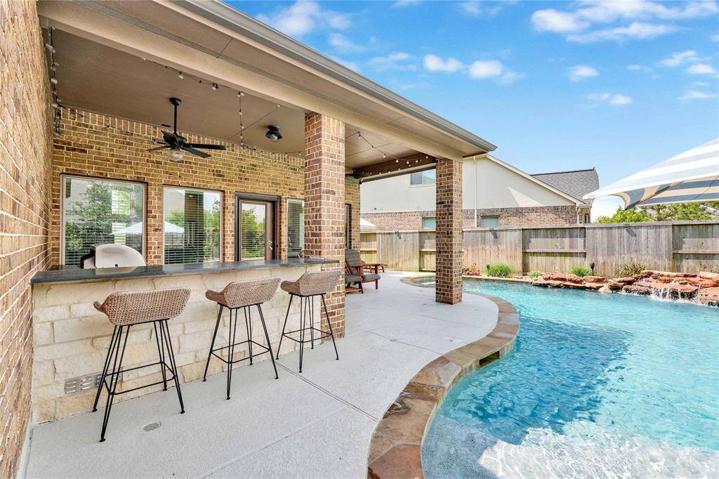 Custom shaded bar seating and natural gas heater pool feature