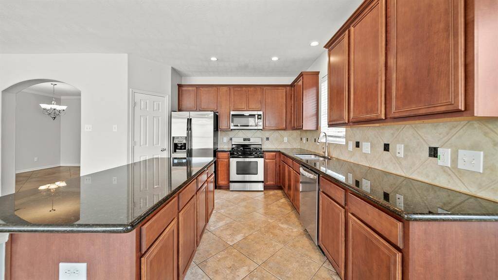 Host your next dinner party with confidence! This masterfully-equipped kitchen features an oversized kitchen island, an abundance of cabinetry and hardware, TONS of counter space, granite countertops and stainless-steel appliances.