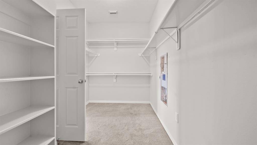This master walk-in closet is very spacious.