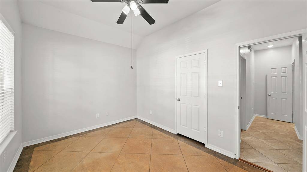This bedroom has easy acess to the foyer, bathroom, an additional secondary bedroom, and the utility room.