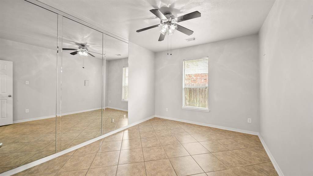 This charming home office is the perfect place to read your favorite book or get some work done! Featuring tile floors, a ceiling fan, and a window with privacy blinds.