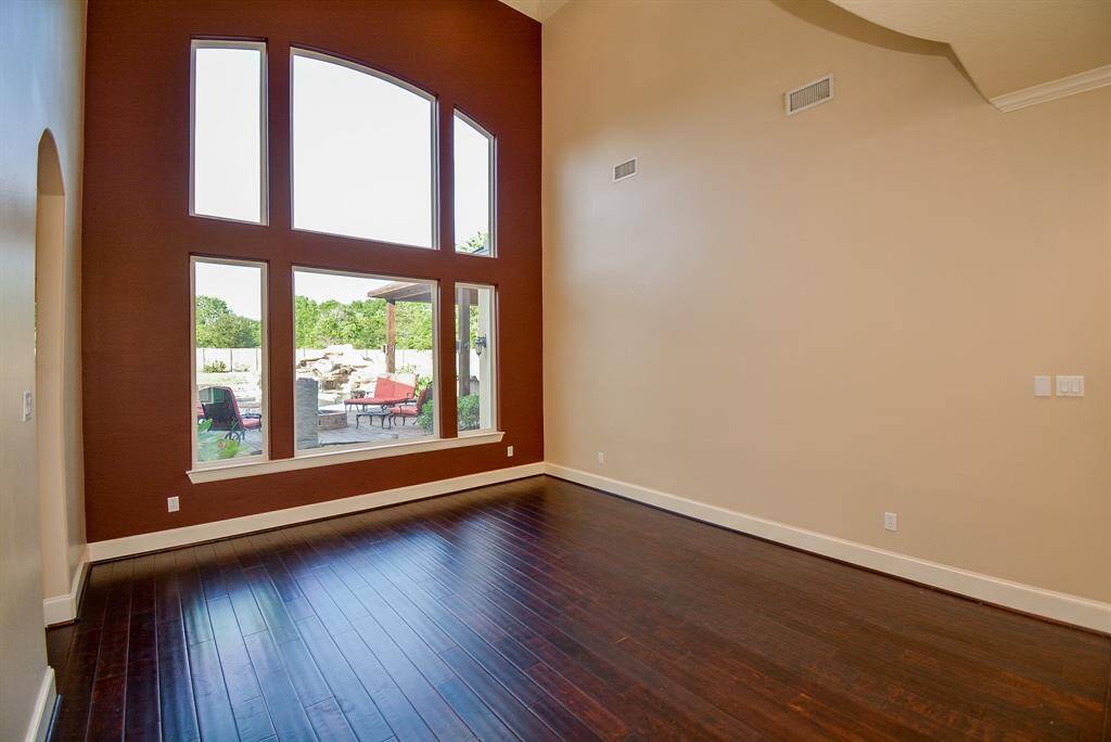 High ceiling, an entire windowed wall, rich hardwood floor and a view of your own private claim to the greater outdoors in back, embraces formal dining events and entertaining.