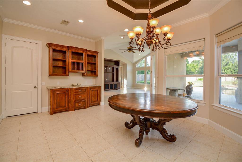 Because of its placement in this wide open, extended kitchen area, we can comfortably call this your breakfast nook! However (and whenever) you decide to us this lush space, it will be a memorable time, surrounded by walls of windows and bright sunshine.