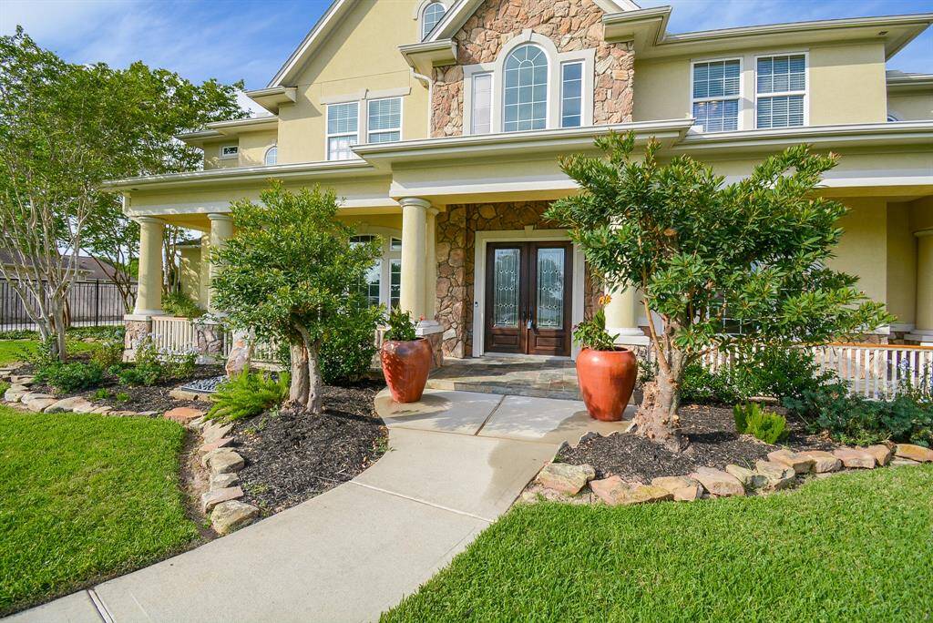 Modestly regal, this up-close view of your paved walkway to the front entrance of your country homestead, is lined with mature native greenery and simple artisan stonework.